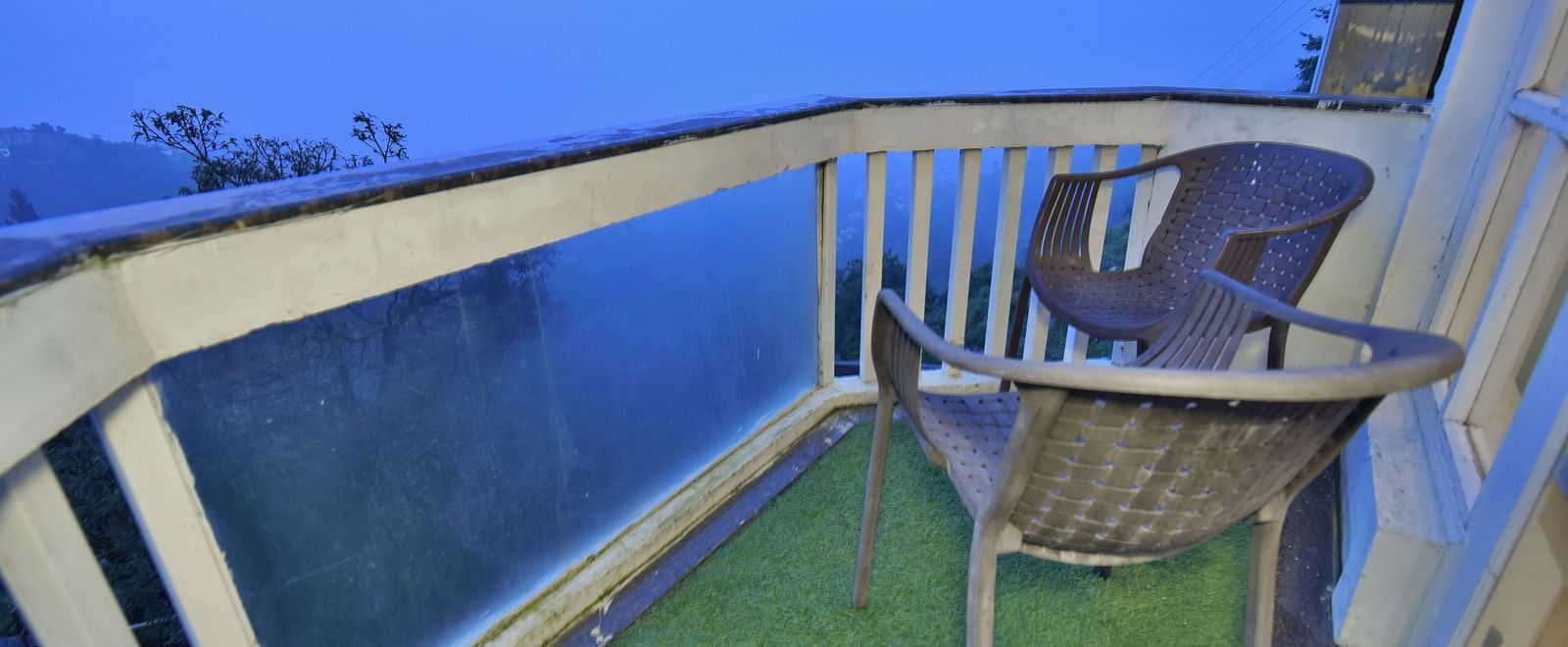 Two chairs placed in the balcony in Luxury Room with Balcony at DLS Highland Resort and Spa, Mussoorie.